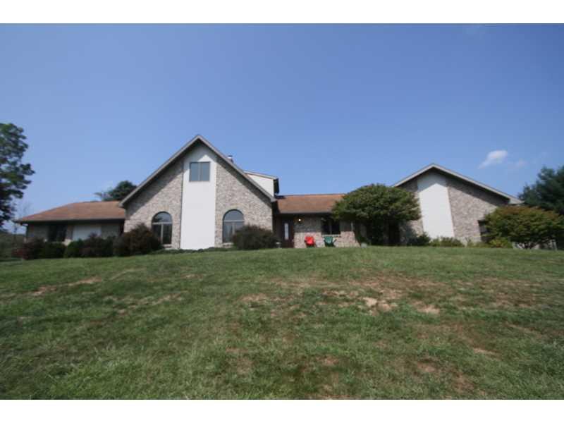 458 School Road Clinton, PA 15026 - Photo 2 of 25 Exterior Front. 100% Gingerbread Brick home with three Garages and a stamped concrete Patio.