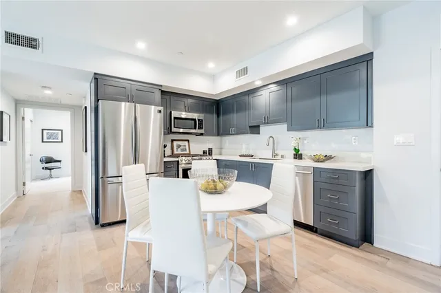 a living room with stainless steel appliances kitchen island granite countertop furniture a kitchen view and a refrigerator