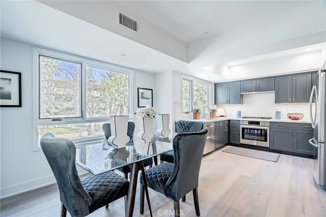 a kitchen with granite countertop cabinets stainless steel appliances and sink