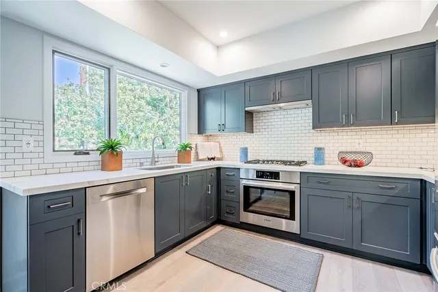 a kitchen with a sink stove and refrigerator