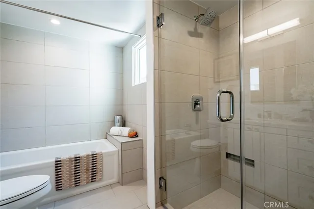 a bathroom with a double vanity sink mirror and toilet