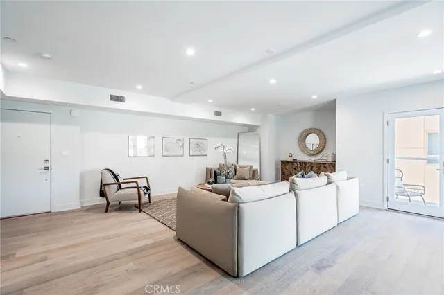 a large white room with furniture and a table