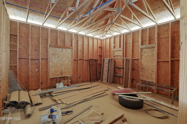 a view of a room with a bed and large windows