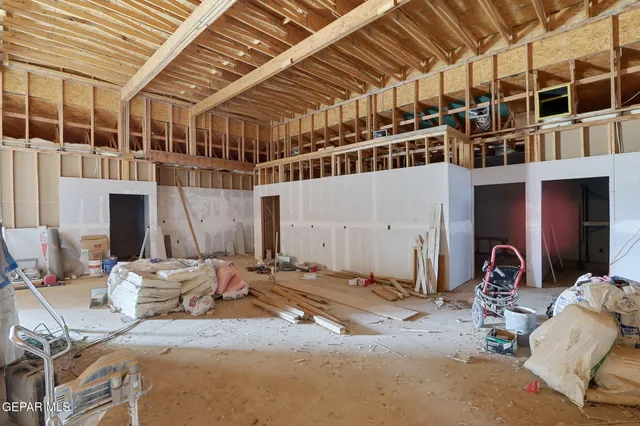 a bedroom with furniture and a large window