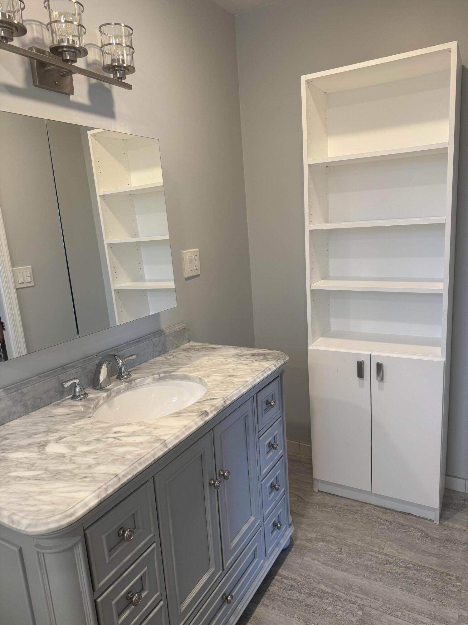 4 Greenway Village North, Unit 203 Royal Palm Beach, FL 33411 - Photo 14 of 19 a bathroom with a granite countertop sink and a mirror