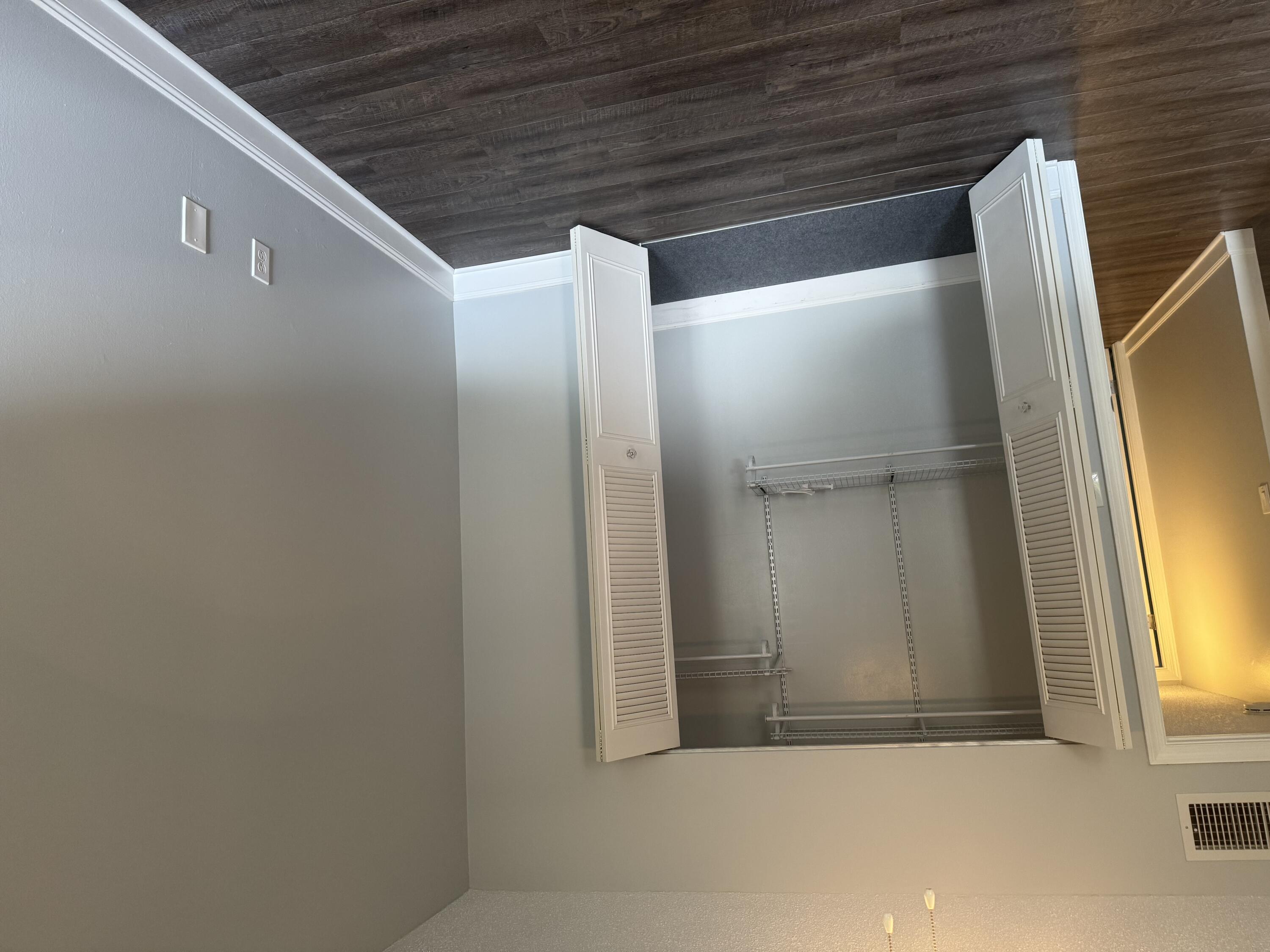 4 Greenway Village North, Unit 203 Royal Palm Beach, FL 33411 - Photo 16 of 19 an empty room with wooden floor and closet