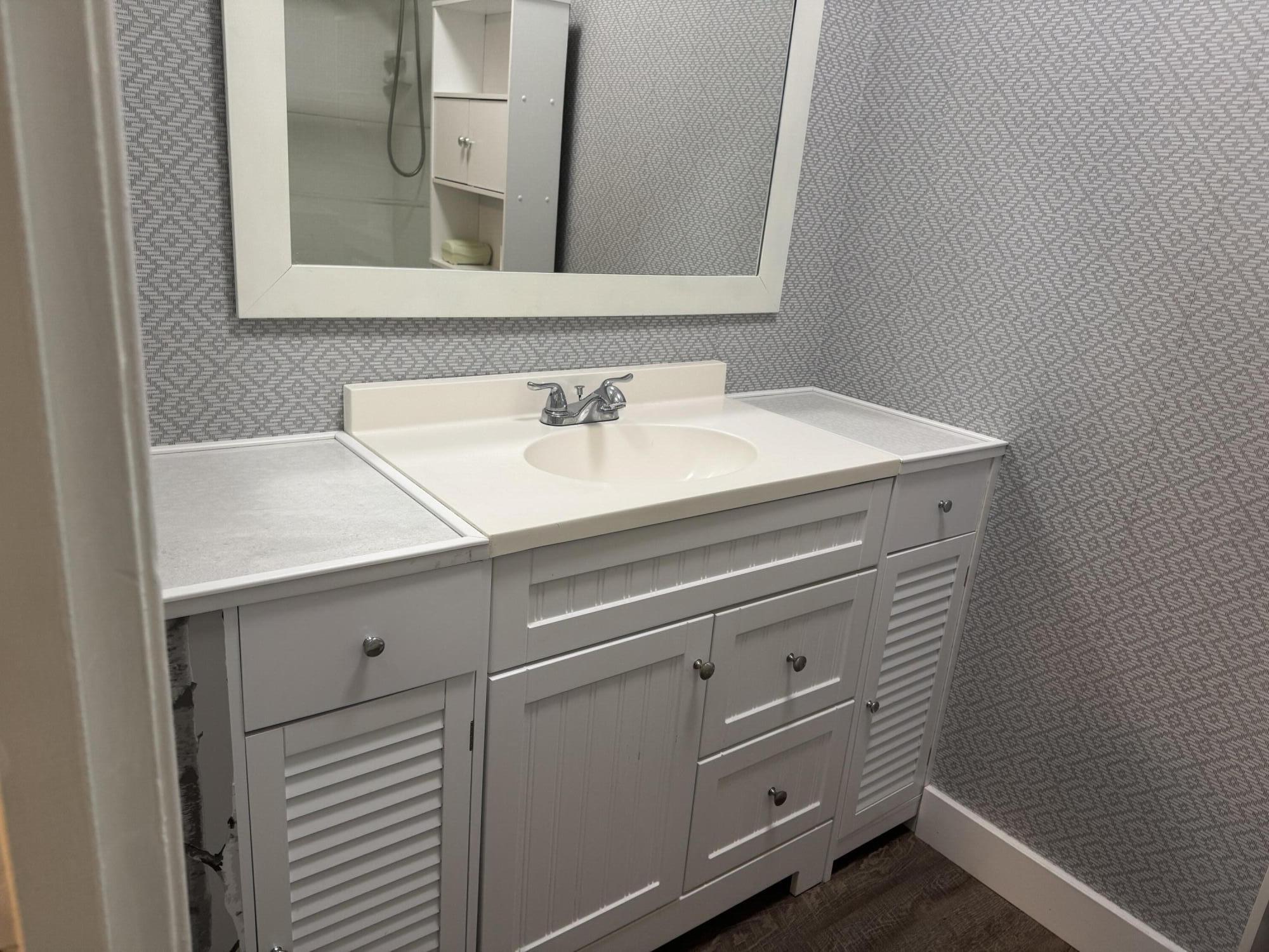 4 Greenway Village North, Unit 203 Royal Palm Beach, FL 33411 - Photo 18 of 19 a bathroom with a sink and a mirror
