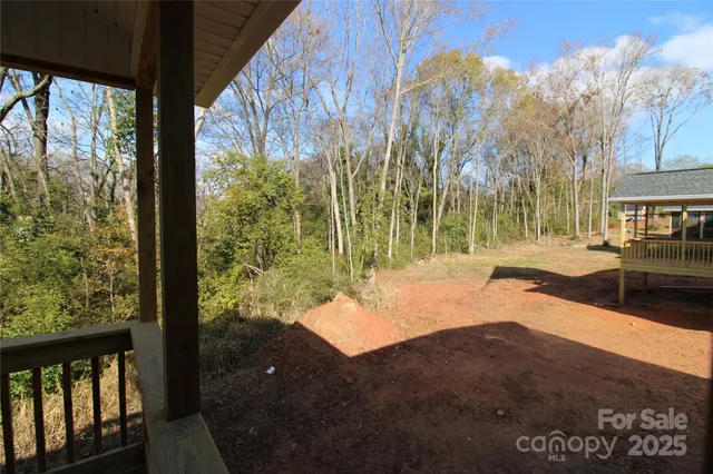 a view of wooden house with a yard