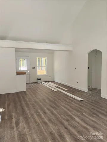 a kitchen with granite countertop wooden floors and white cabinets