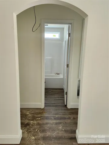 a kitchen with granite countertop white cabinets and sink