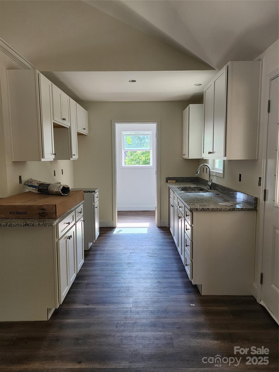 150 Hinton Street Chester, SC 29706 - Photo 21 of 22 a kitchen with granite countertop wooden floors and white cabinets