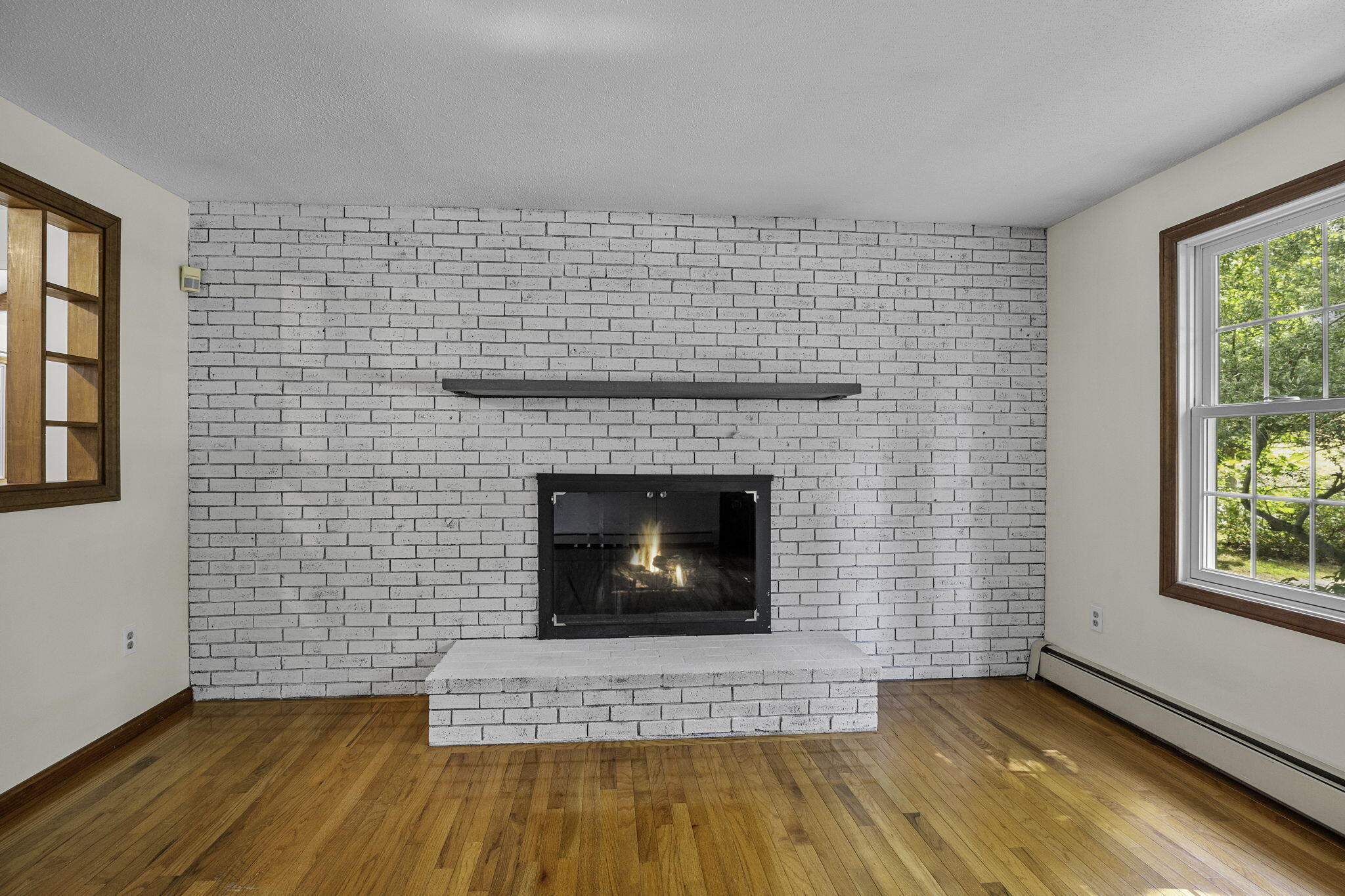 5 Carl Gardner Road Monument Beach, MA 02532 - Photo 12 of 29 a living room with a fireplace and a rug