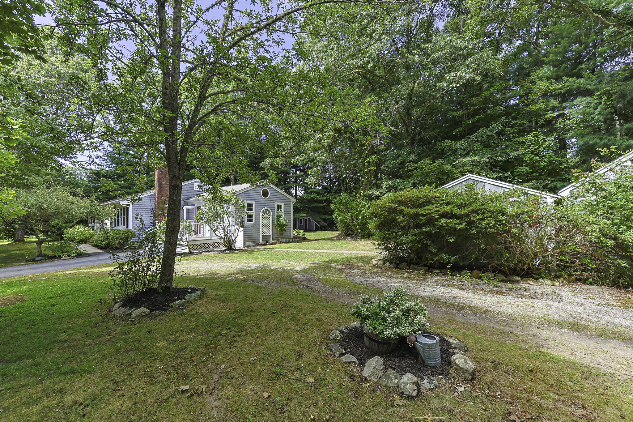 5 Carl Gardner Road Monument Beach, MA 02532 - Photo 26 of 29 a backyard of a house with a garden and plants