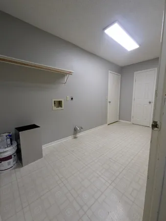 a view of an empty room and a window