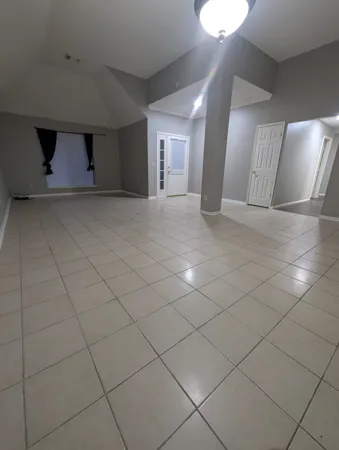 a room with wooden cabinets and stainless steel appliances