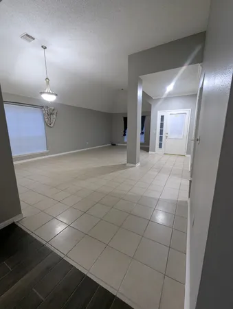 a view of an empty room and a window