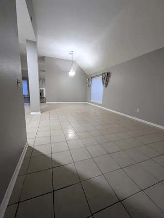 a view of empty room with wooden floor and fireplace