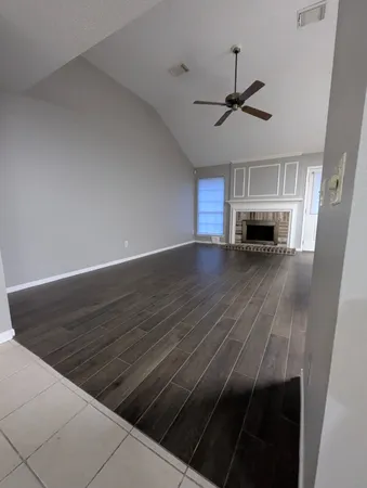 a view of empty room with a fireplace