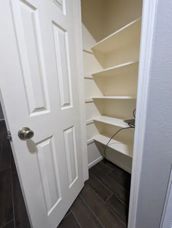 a view of staircase with white walls and a window