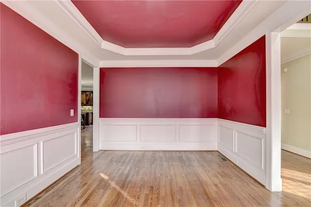 a view of a livingroom with wooden floor and stairs