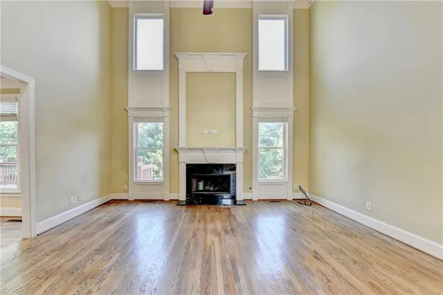 a view of an empty room and chandelier fan