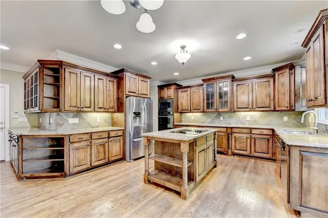 an empty room with chandelier fan and windows