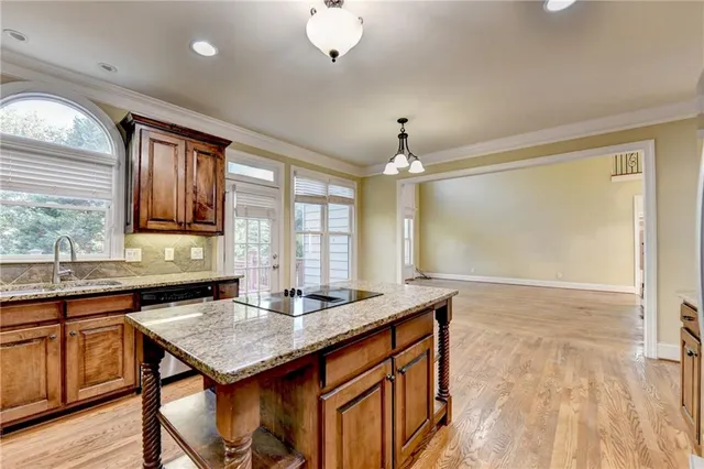 a view of an empty room with a fireplace and a window