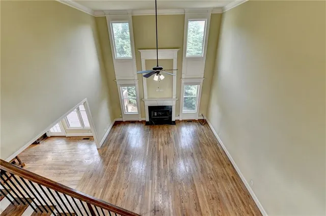 an aerial view of a swimming pool with a yard and plants