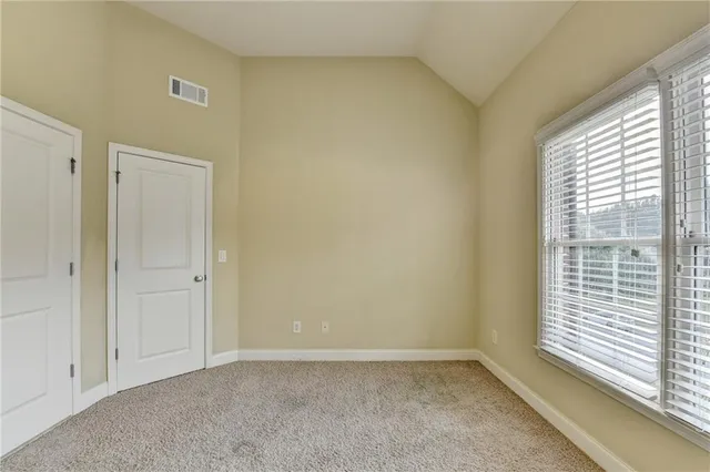 an aerial view of a tennis ground and a yard
