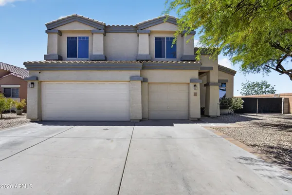 front view of a house with a yard and a garage