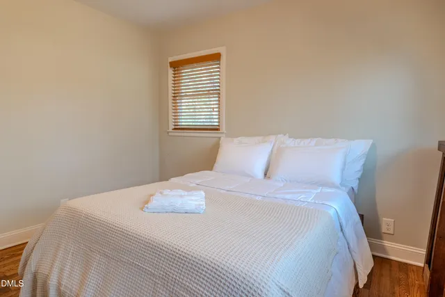 a bedroom with a bed and a window