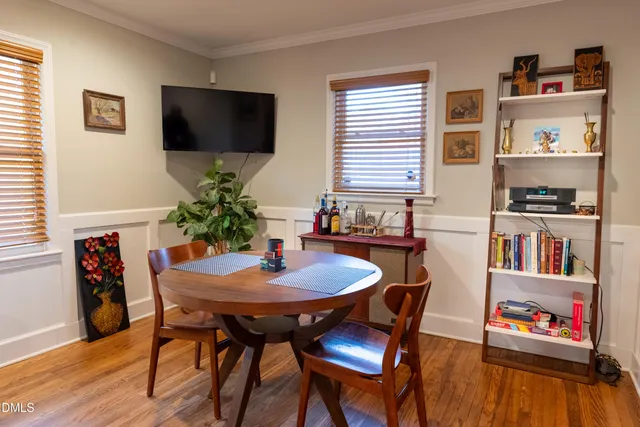 a dining room with furniture and wooden floor