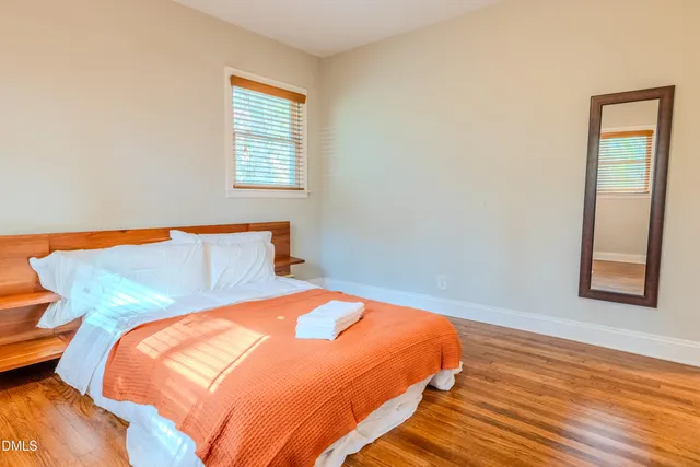 a bedroom with a bed and window