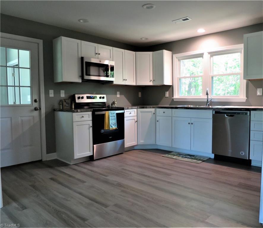 116 Spillman Road Mocksville, NC 27028 - Photo 8 of 32 Kitchen is Open and Airy with New Stainless Appliances that Remain.