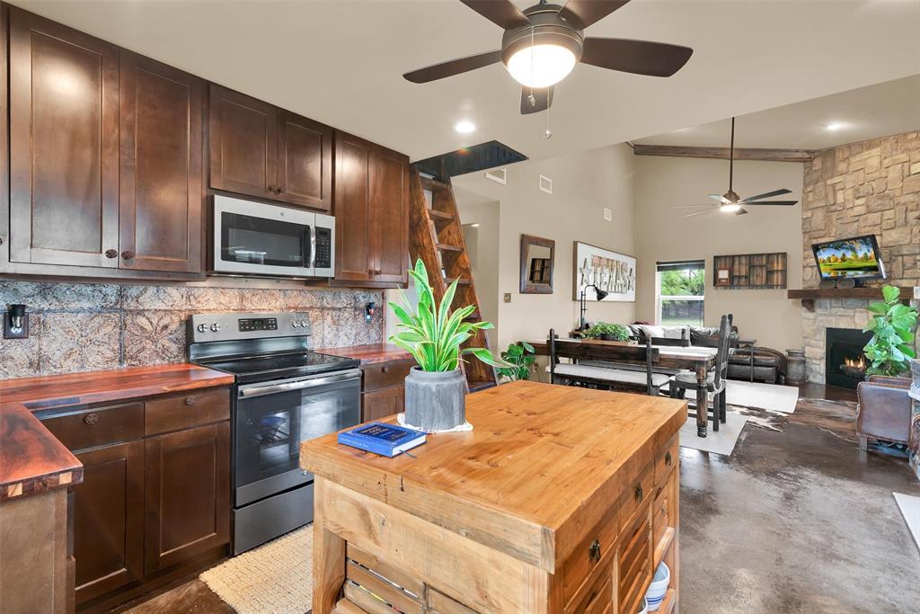 8665 Cr-669 Blue Ridge Blue Ridge, TX 75424 - Photo 39 of 39 a kitchen with a table chairs microwave and refrigerator