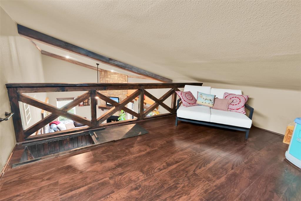 8665 Cr-669 Blue Ridge Blue Ridge, TX 75424 - Photo 23 of 39 a living room with exposed pipes and a wooden floor