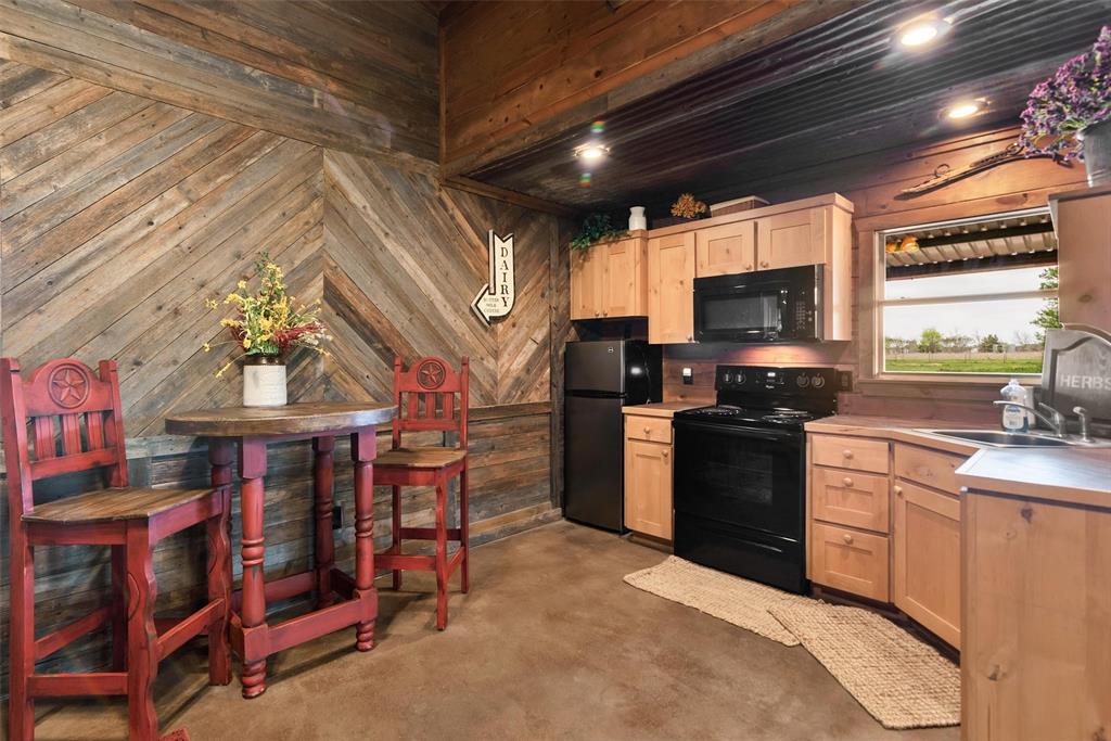 8665 Cr-669 Blue Ridge Blue Ridge, TX 75424 - Photo 27 of 39 a kitchen with stainless steel appliances granite countertop a stove and a refrigerator