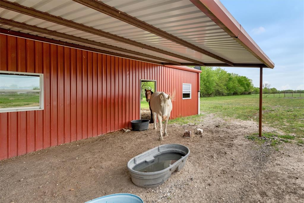 8665 Cr-669 Blue Ridge Blue Ridge, TX 75424 - Photo 32 of 39 a view of a backyard with table and chairs and wooden fence