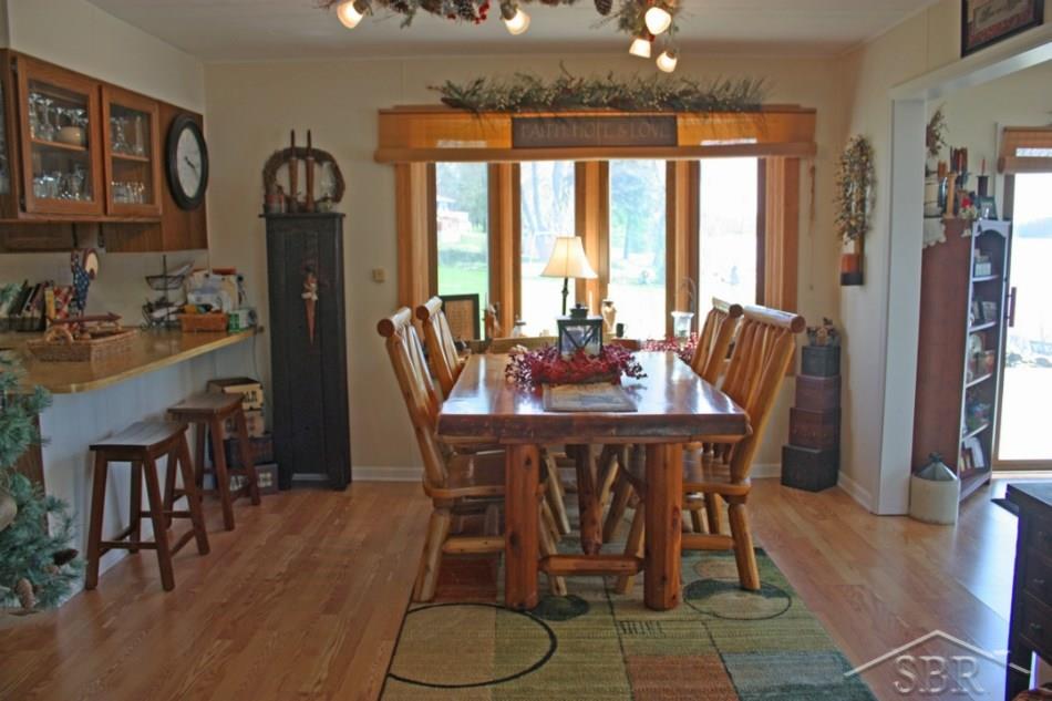 3072 South Whitney Beach Road Beaverton, MI 48612 - Photo 8 of 21 12x12 dining room provides enough room for everyone. to the left the bar style counter top in the kitchen provides even more seating area.