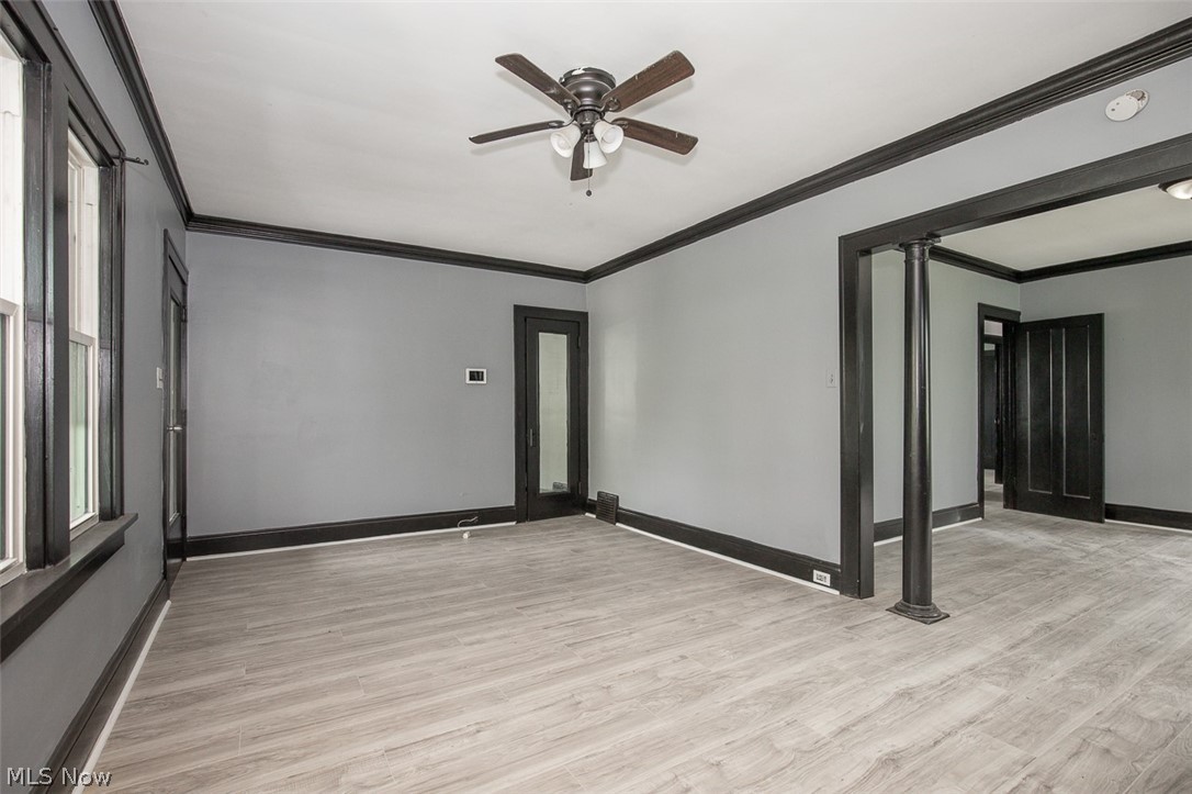 1868-1870 Lampson Road Cleveland, OH 44112 - Photo 21 of 36 Spacious room featuring light wood-finish flooring, a ceiling fan with integrated lighting, and dark trim