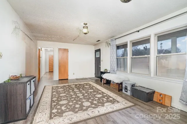 a large room with a rug and wooden floor