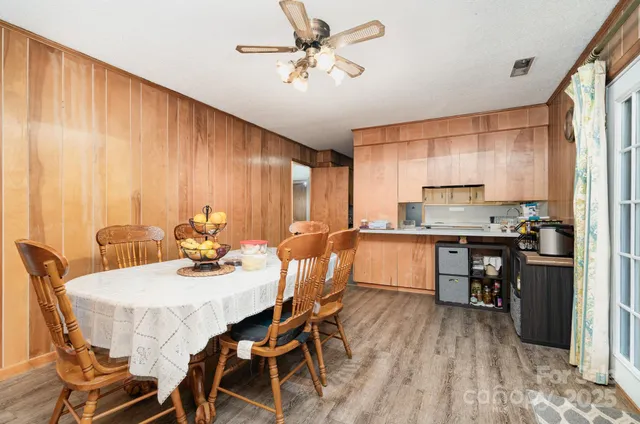 a kitchen with a table chairs stove and refrigerator