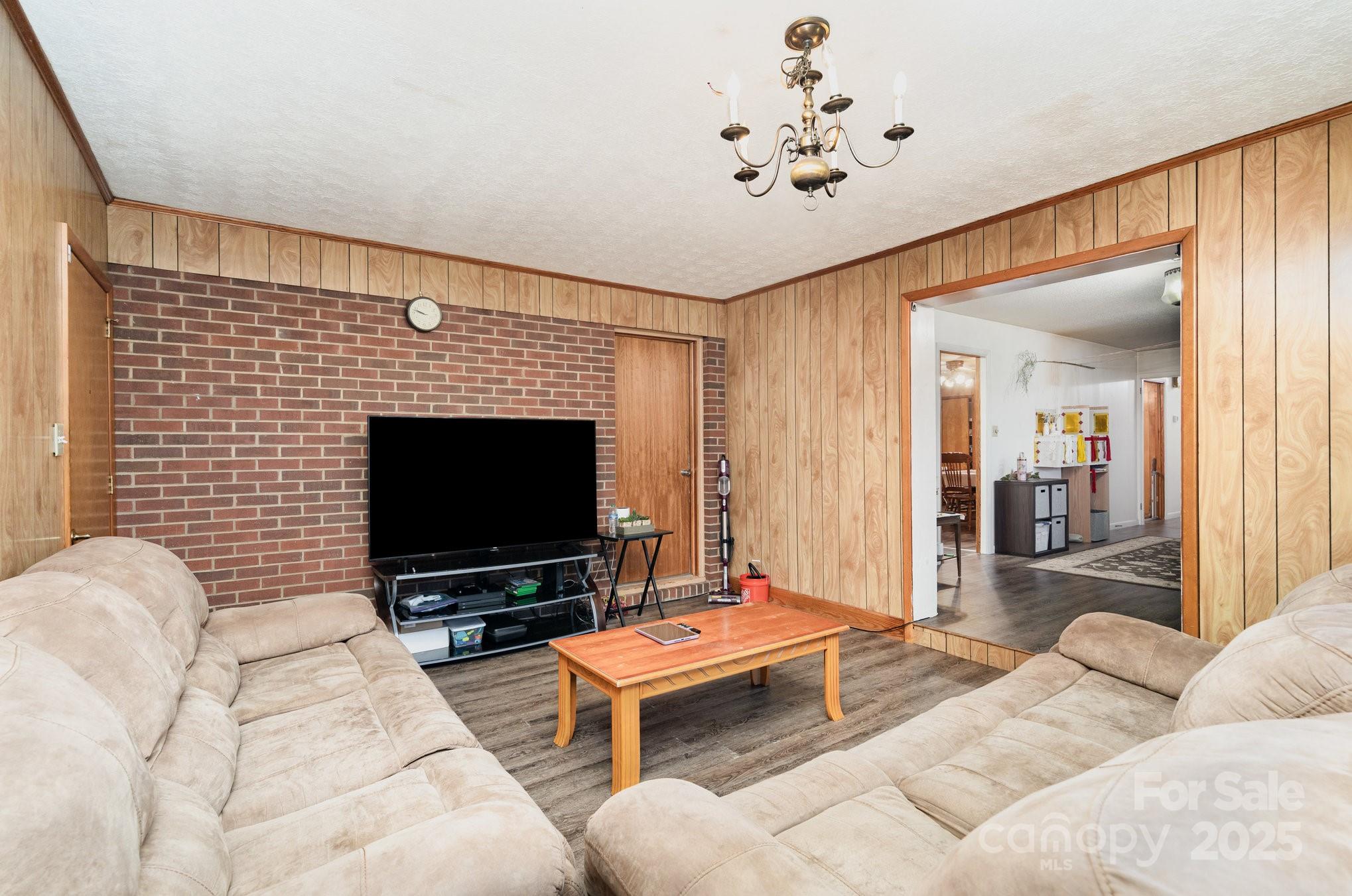 4458 Johnson Bridge Road Hickory, NC 28602 - Photo 16 of 31 a living room with furniture and a flat screen tv