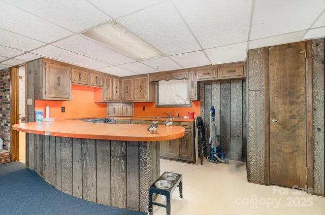 a room with stainless steel appliances kitchen island a table and chairs
