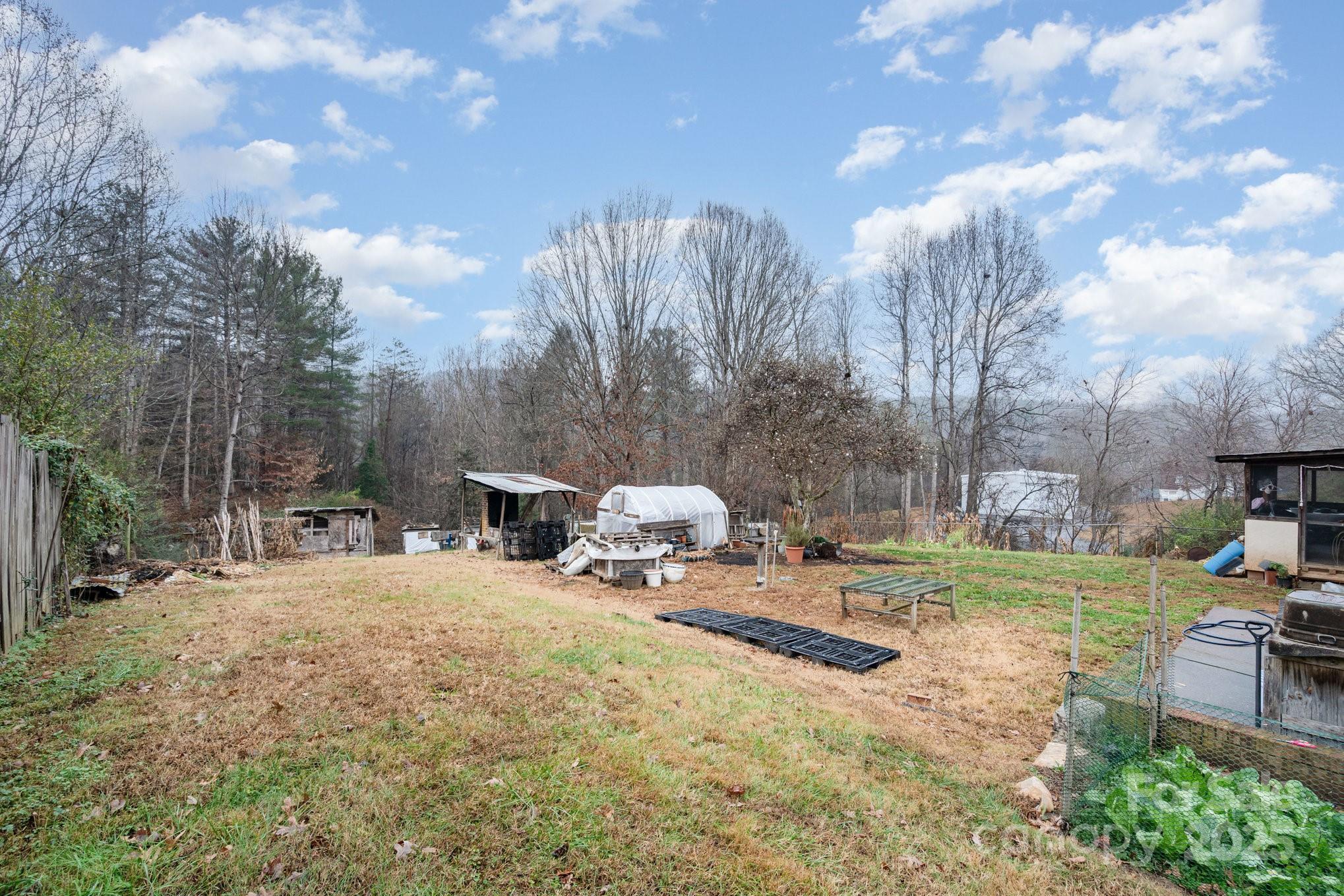 4458 Johnson Bridge Road Hickory, NC 28602 - Photo 30 of 31 a backyard of a house with table and chairs