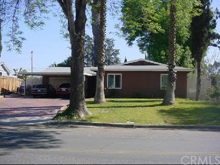 6704 Lake Street Riverside, CA 92503 - Photo 1 of 1 a front view of a house with a garden and tree
