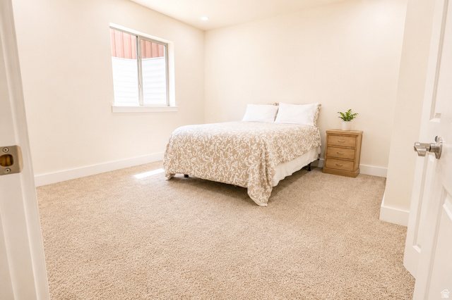 1055 North 1000 East Mapleton, UT 84664 - Photo 66 of 112 Carpeted room featuring a window with a white frame and blinds, light cream wall paint, and white baseboards