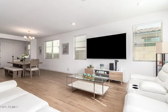 a living room with furniture and kitchen view