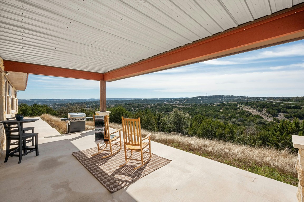 Side patio with panoramic hill country views; Main house has 3401 sq. ft., 3 bedrooms, 3.5 baths, flex/office space and panoramic hill country views from almost every room; The apartment over garage is 1145 sq. ft., 2 bedroom/2 bath, separate entrance, perfect for guest or rental income.