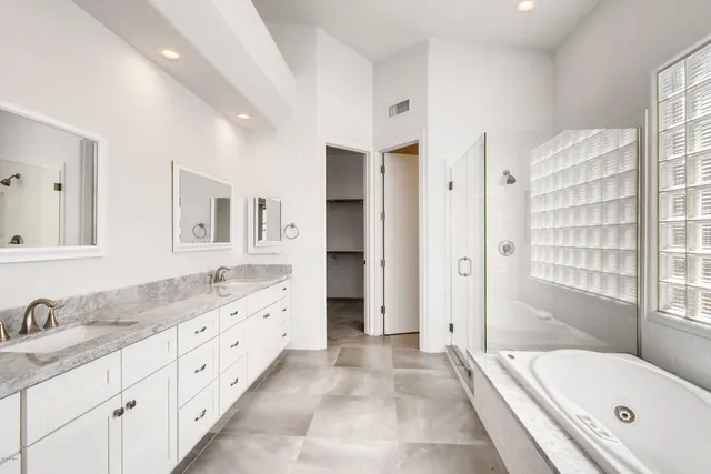 a view of a street with flower garden in front of it